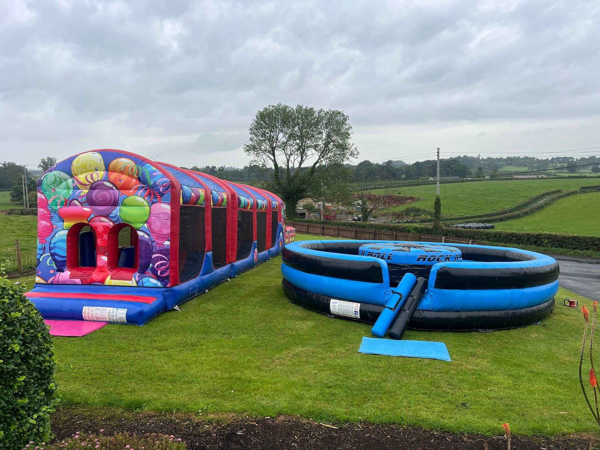 Bouncy castle assault course and rock and roller inflatable in garden party planning in Larne