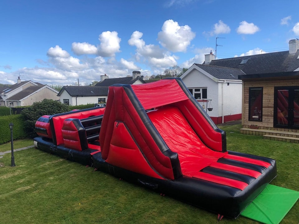 Red bouncy castle with a slide best party supplier Lisburn BT27 BT28