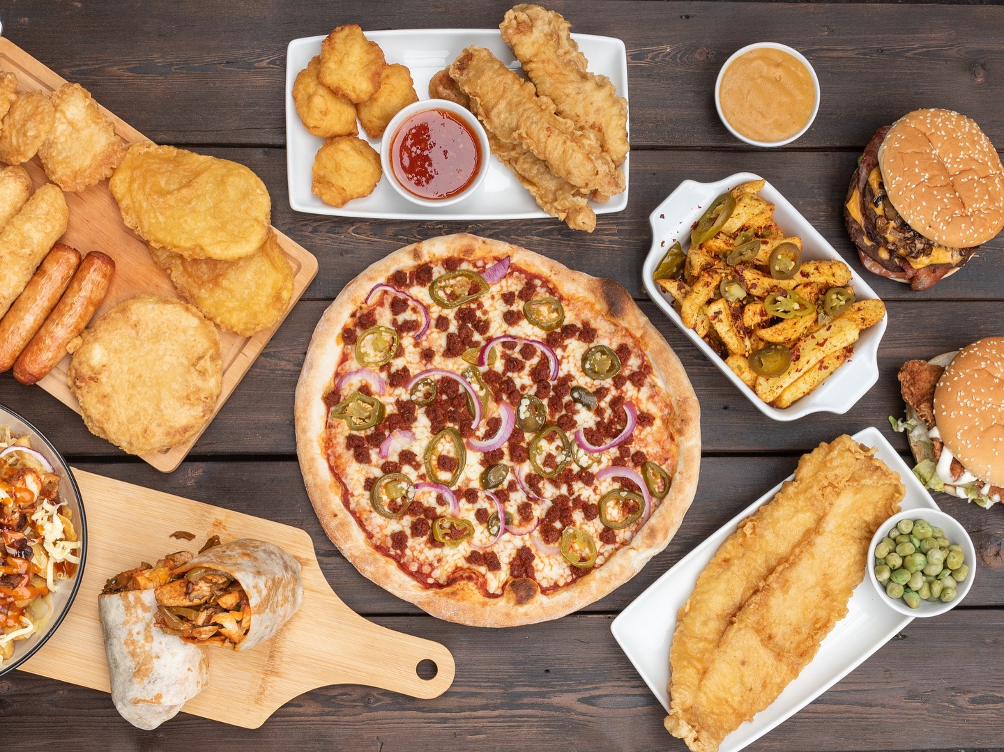 Party food platter with pizza, burgers, chicken nuggets and chips