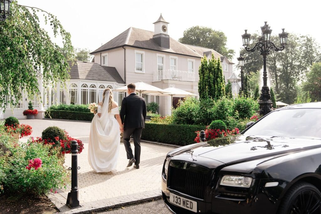 A bride and groom arriving at Tullyglass. Read the tullyglass house hotel wedding review here